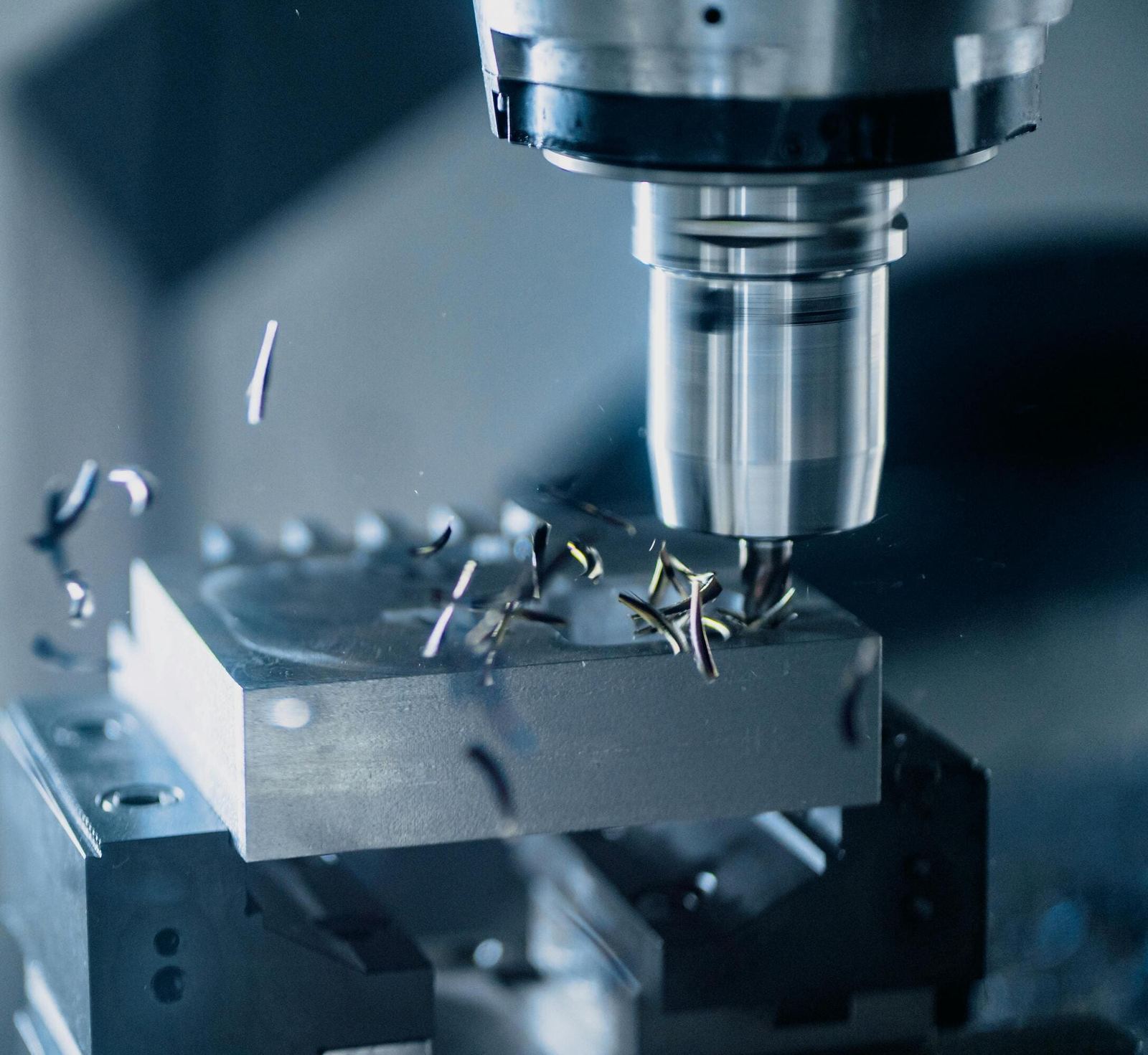 End mill cutting an aluminium block, chips in flight