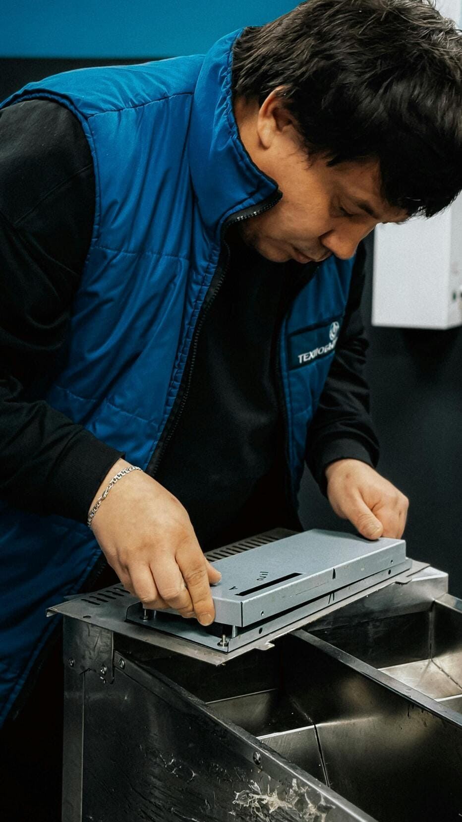 Technician checking a plated sheet metal component